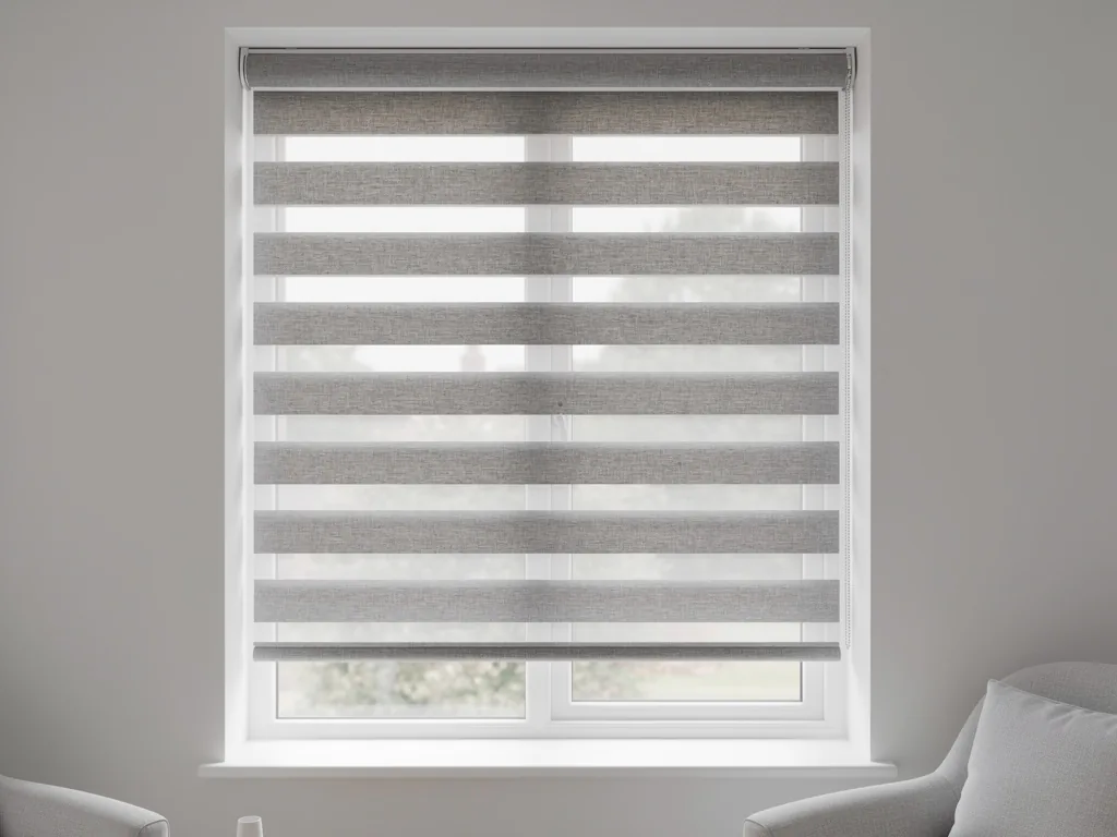 A day and night roller blind with alternating sheer and opaque bands at a living room window